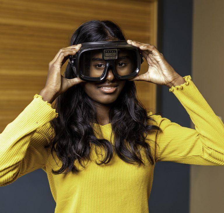 A person wearing Fatal Vision glasses