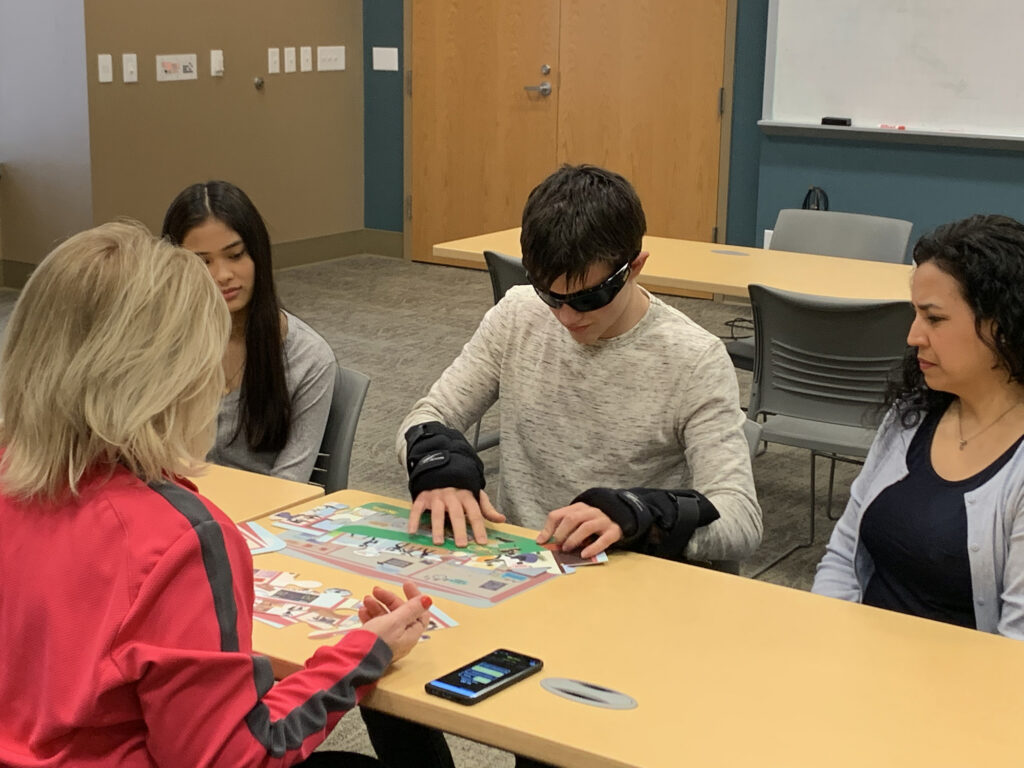 Educator demonstrating opioid abuse prevention program tools with Fatal Vision simulation goggles