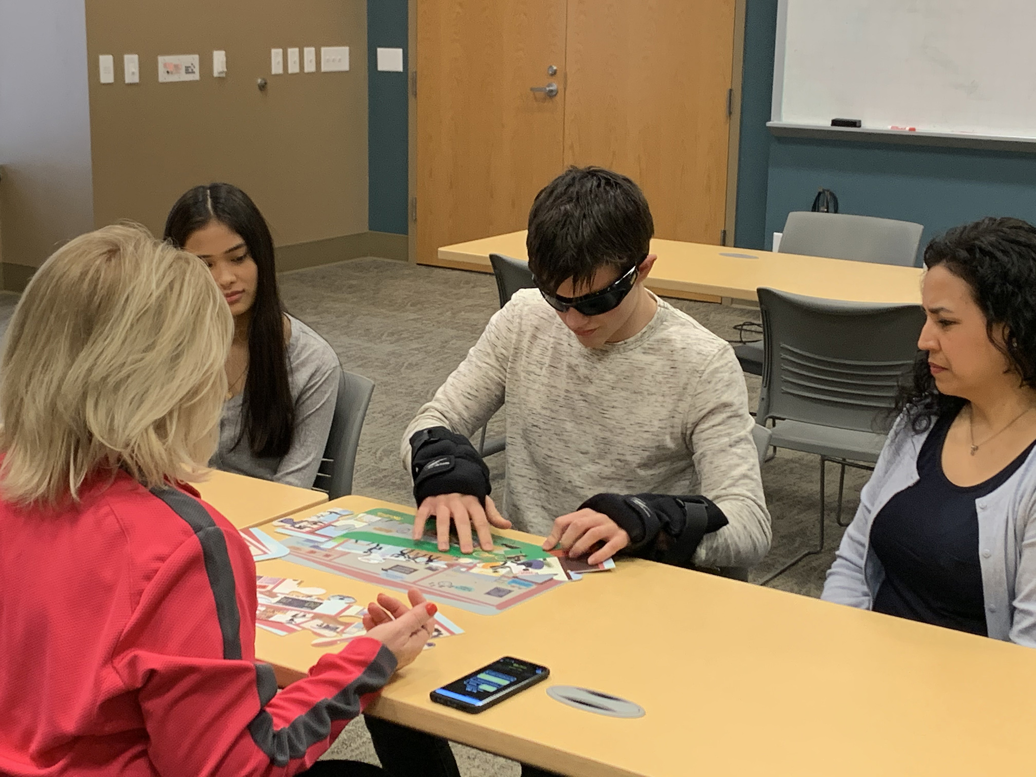 Educator demonstrating opioid abuse prevention program tools with Fatal Vision simulation goggles