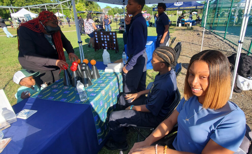 Officer Woods demonstrating Fatal Vision Impaired Simulation Goggles to Detroit Police Explorers
