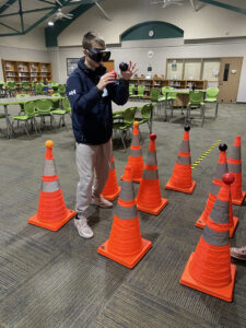 STATS student navigates impaired driving simulation course with Fatal Vision goggles