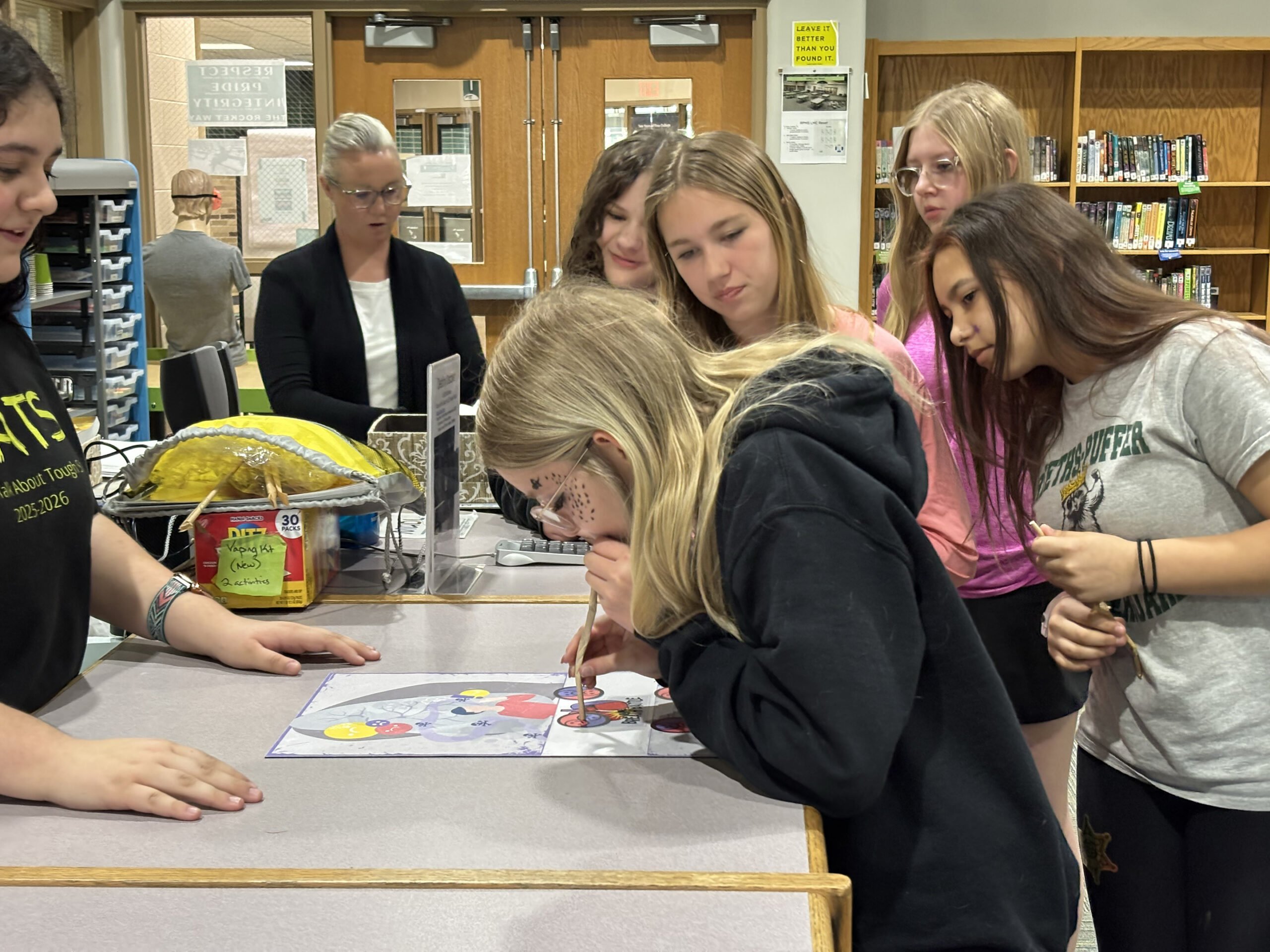 Law enforcement officer tries Fatal Vision impairment goggles activity with students